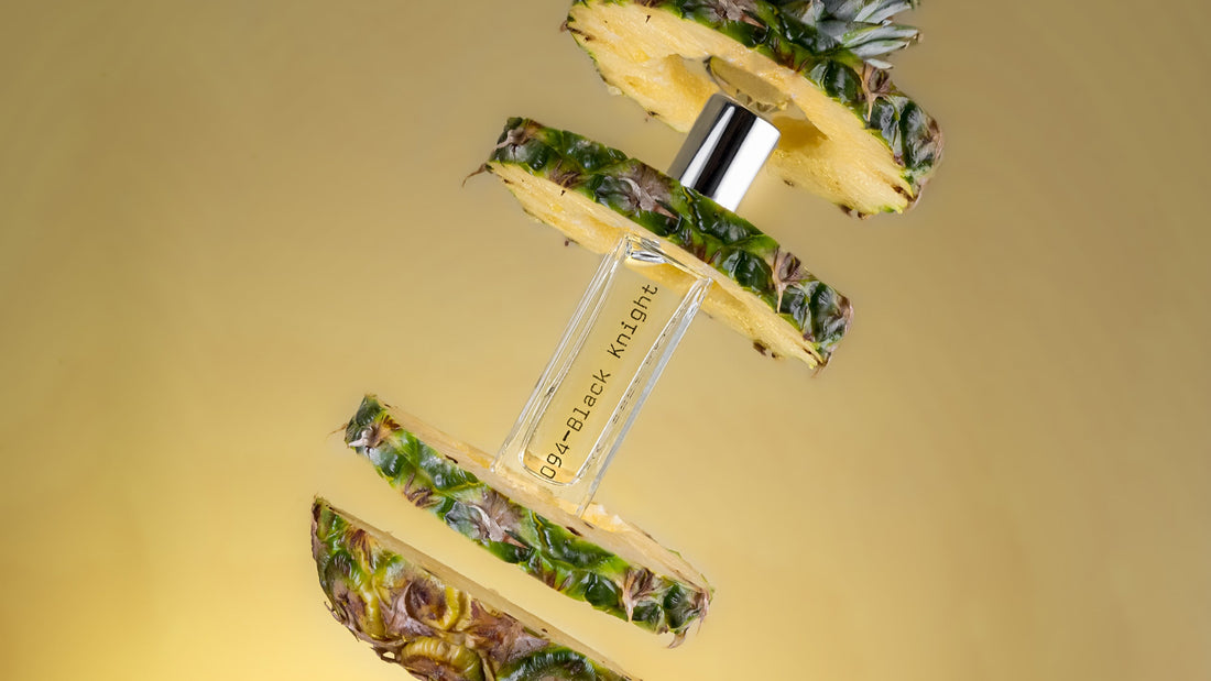 Perfume bottle with pineapple design on a gold background