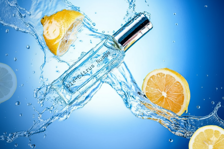 Bottle of Citrus Nectar with lemon slices and water splash on a blue background