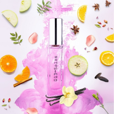 Perfume bottle with fruit slices and flowers on a colorful background