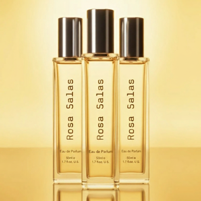Three bottles of Rosa Salas perfume on a gold background
