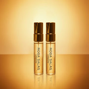Two Rosa Salas London perfume bottles on a gold background