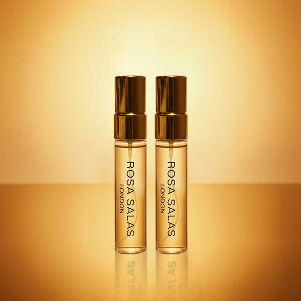 Two Rosa Salas London perfume bottles on a gold background
