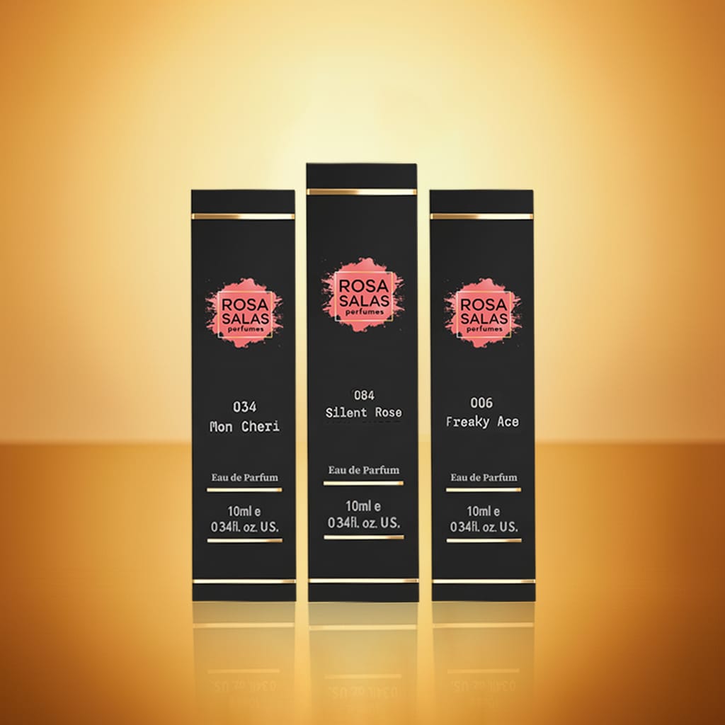Three black perfume bottles with 'Rosa Salas' branding on a gold gradient background