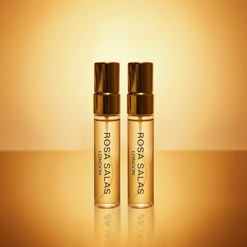 Two Rosa Salas London perfume bottles on a gold background
