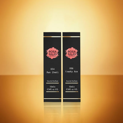 Two black perfume bottles with 'Rosa Salas' branding on a gold gradient background